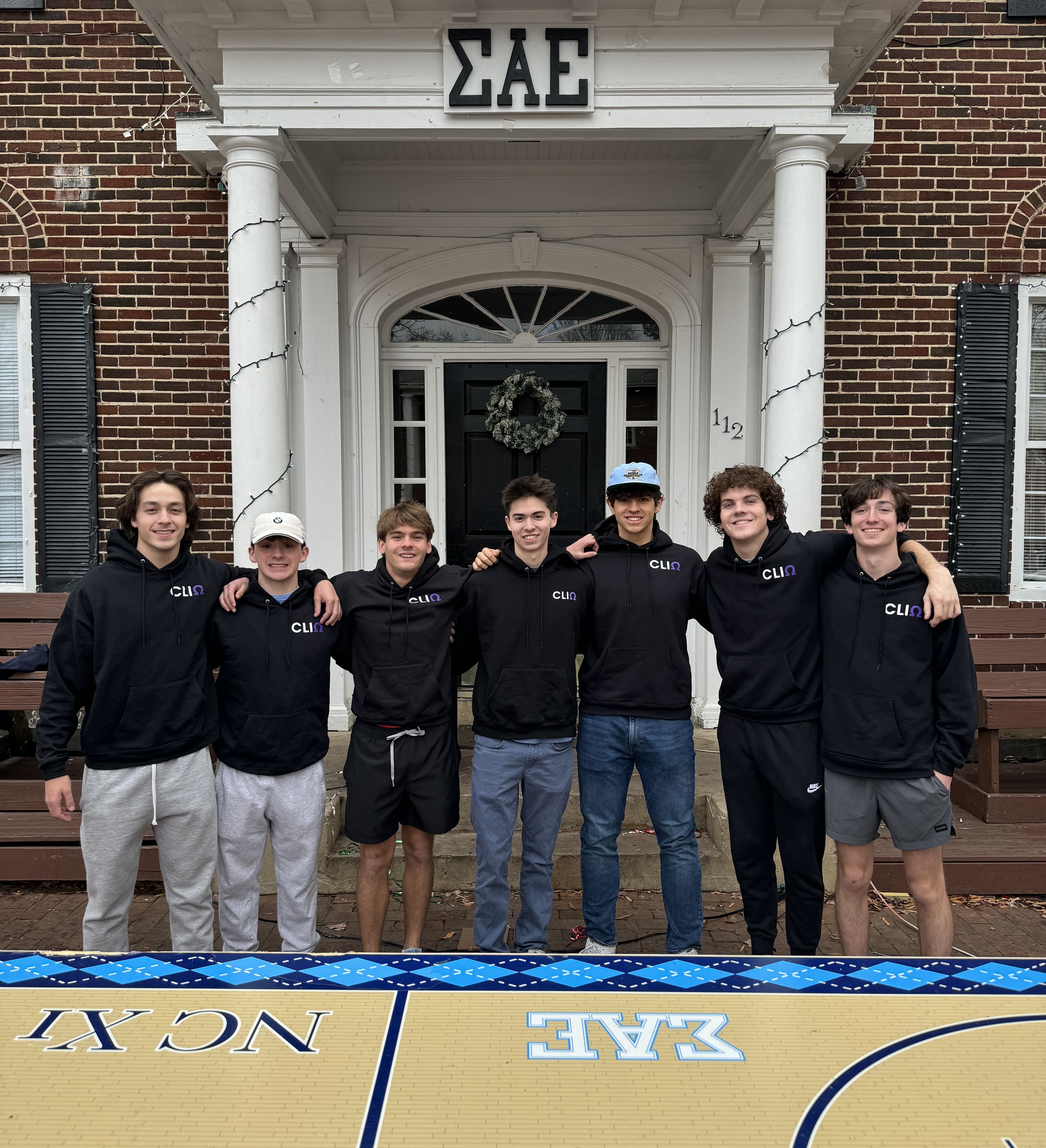 The CLIQInvite team posing with fraternity brothers in front of UNC's chapter of SAE, Steve Draughn's fraternity chapter